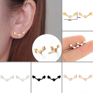 Detailed view of triple heart ear climbers in gold, silver, black and rose gold finishes
