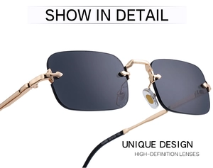 Détail de lunettes de soleil sans monture avec branches dorées et décor de flèche