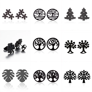 Nine pairs of black stainless steel stud earrings featuring tree of life and clover designs