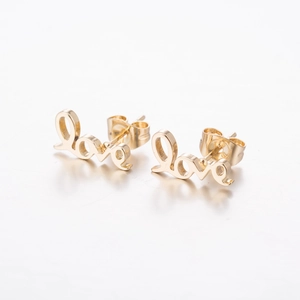Detail shot of golden Love script earrings with butterfly backs and polished finish