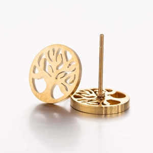 Close-up of golden Tree of Life stud earrings with intricate hollow design and brushed finish
