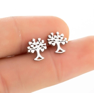 Detailed close-up of hollow silver stainless steel tree of life stud earring on fingers