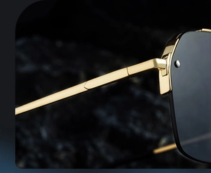 Macro view of bright gold metal temples and precise hinge detail on half-rim sunglasses