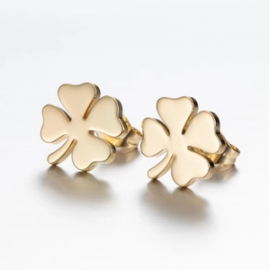 Detailed macro view of gold-plated clover stud earrings with a polished metallic finish