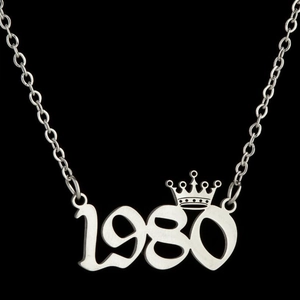 Detailed close-up of crown year 1980 number pendant on silver stainless steel link chain