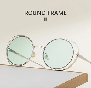 Detail of silver hollow round frame sunglasses with mint green lenses and adjustable nose pads