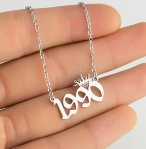 Detail of 1990 crown number pendant necklace in polished silver stainless steel