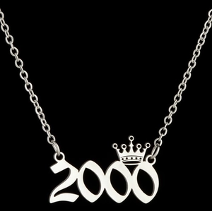 Close-up of silver stainless steel necklace with year 2000 pendant and crown detail