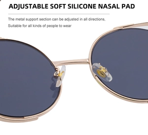 Detail of adjustable soft silicone nose pads on gold metal round frame sunglasses