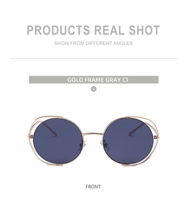 Front view of stylish gold metal hollow frame round sunglasses with dark grey lenses