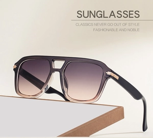 Detail of vintage square sunglasses with gradient lenses and elegant gold metal hinge