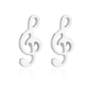 Macro detail of silver treble clef music note earrings with polished metal finish