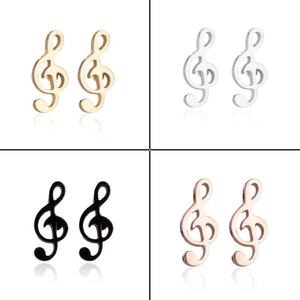 Detail view of musical note stud earrings in gold, silver, black, and rose gold finishes