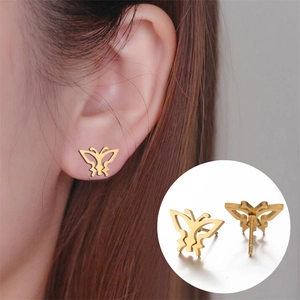 Elegant gold hollow butterfly stud earrings in stainless steel on a model