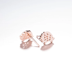 Detailed close-up of hedgehog stud earrings in rose gold finish with hollow out design
