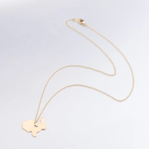 Close-up of golden bunny silhouette pendant with heart cutout on fine chain