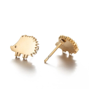 Macro detail of golden hedgehog stud earrings featuring a brushed matte metallic finish