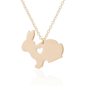 Macro shot of golden rabbit pendant with heart-shaped cutout on minimalist necklace