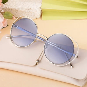 Silver round hollow frame sunglasses with blue gradient lenses and beige leather case