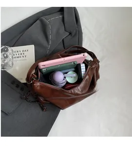Spacious interior of brown crocodile pattern tote bag holding tablet and umbrella