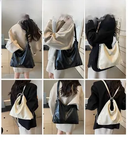 Detail view of large tote bag with quilted texture and metal chain strap options