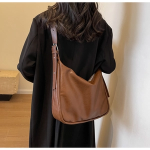 Brown vintage hobo bag details showing adjustable strap and matte leather texture