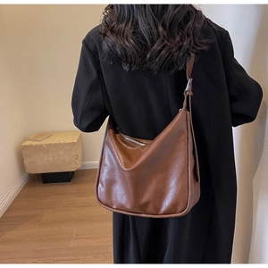 Brown vintage hobo bag shown on model highlighting large capacity and soft PU leather texture