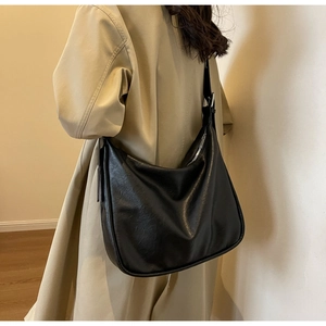 Detailed view of large black matte leather hobo bag with adjustable shoulder strap
