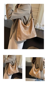 Detail of tan crocodile texture faux leather tote bag with chain strap and stitch pattern