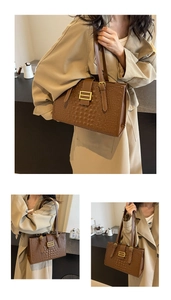 Detail of dark brown faux leather shoulder bag with crocodile texture and metal buckle