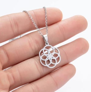 Close-up of geometric hollow flower pendant on a fine silver stainless steel chain