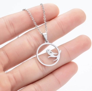 Detail of laser cut bird on branch pendant necklace in polished stainless steel
