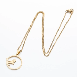 Detail of laser cut gold bird pendant on branch with fine stainless steel O-chain link