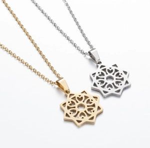 Macro detail of geometric hollow star pendants with heart patterns in gold and silver