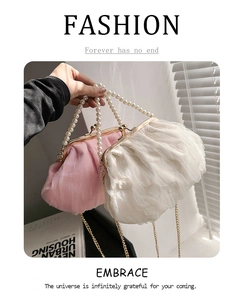Detail of vintage pleated cloud bag with pearl handle and metallic chain strap