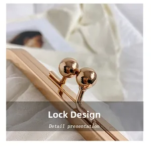 Macro shot of polished pale gold kiss-lock metal hardware on a stylish lace handbag