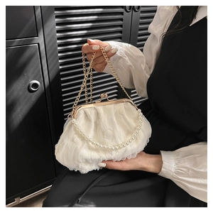 Close-up of white lace pleated cloud bag with pearl handle and gold metal chain strap
