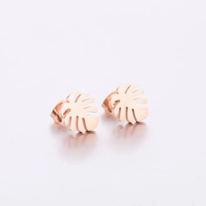 Macro shot of rose gold monstera leaf stud earrings with detailed hollow out texture