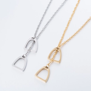 Minimalist stainless steel horseshoe pendant necklace in polished gold and silver finishes