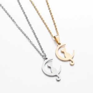 Fashionable moon and cat pendant necklaces in gold and silver set on white background