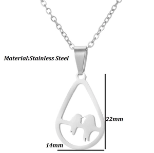 Macro view of geometric cutout bird pendant in stainless steel with size measurements