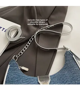 Detail of blue denim baguette bag with dual straps including silver mirror leather option