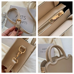Detail view of cream handbag with textured synthetic leather and gold hardware