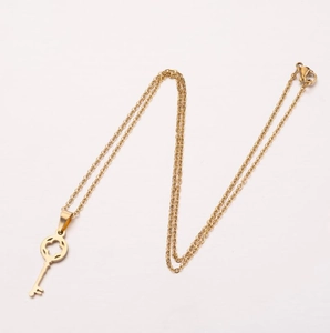 Minimalist 18K gold plated stainless steel key pendant necklace for women on white background