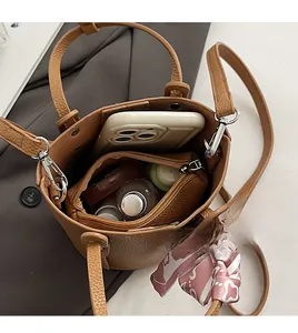 Interior view of brown pebble leather bucket bag showing large capacity and silk scarf