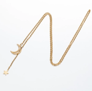 Minimalist gold moon and star pendant necklace with fringe chain on white background