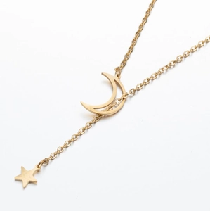 Detail shot of golden star and moon lariat necklace with polished cutout moon pendant