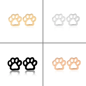 Close-up of animal paw print stud earrings in gold, silver, black and rose gold steel