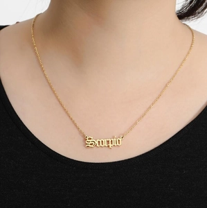 Golden Scorpio zodiac pendant necklace with minimalist gothic font on a delicate chain