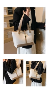 Detail of contrast stitch tote bag with gold buckle and pebble leather texture